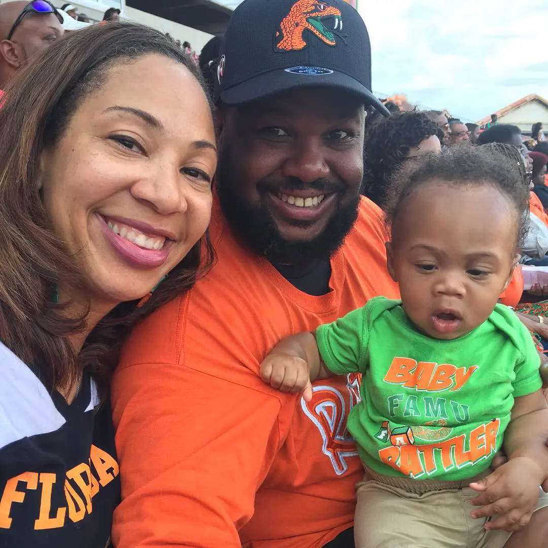Tiffany with Aaron and son Bryson watching football game.