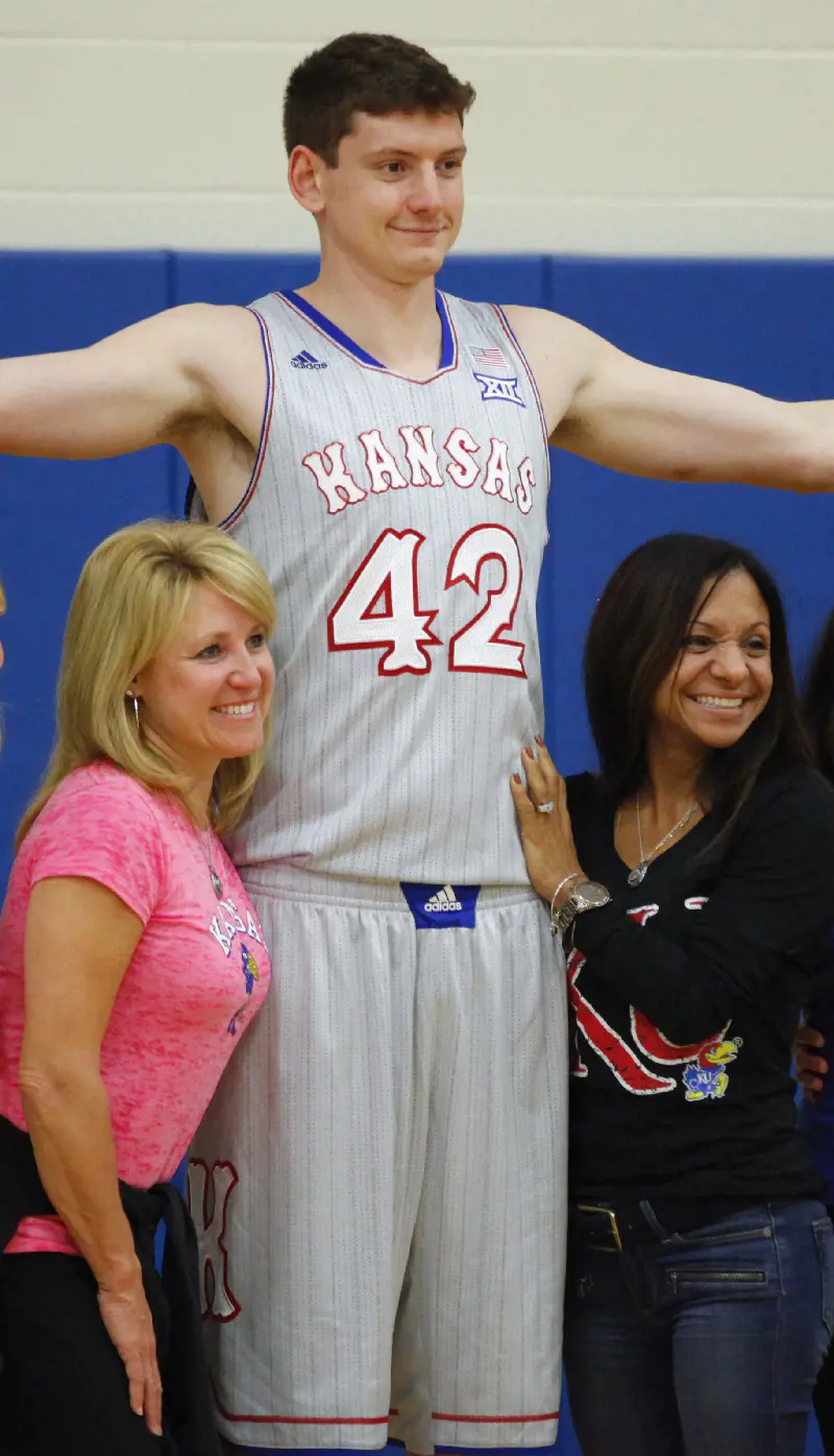 Pascale(right) with Kansas player Hunter Mickelson and Cindy Self(left) during a photoshoot event.