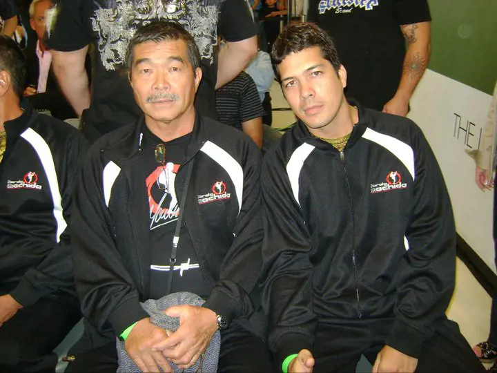 Yoshinzo and Take donning Machida Karate's tracksuit while attending an event in Las Vegas