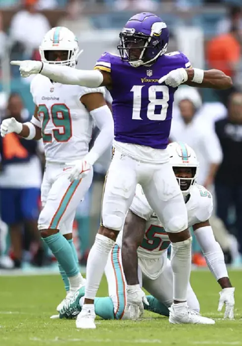 A picture of Minnesota Vikings player while playing against Miami Dolphins.
