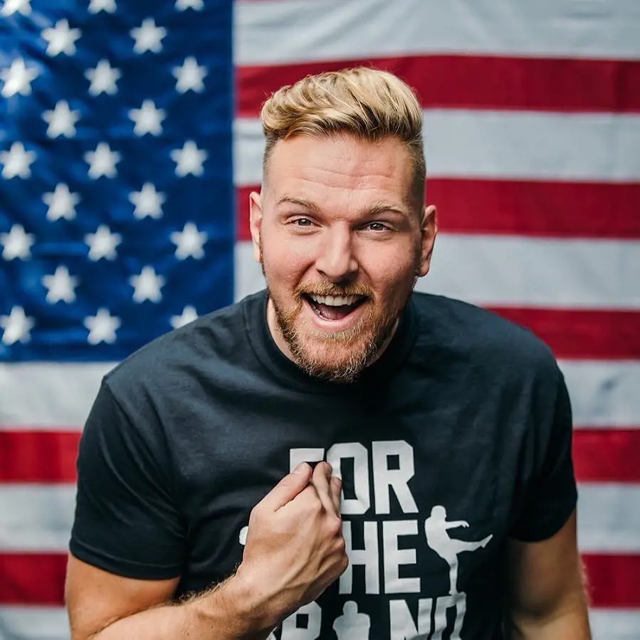 McAfee striking a pose infront of USA flag in May 2022
