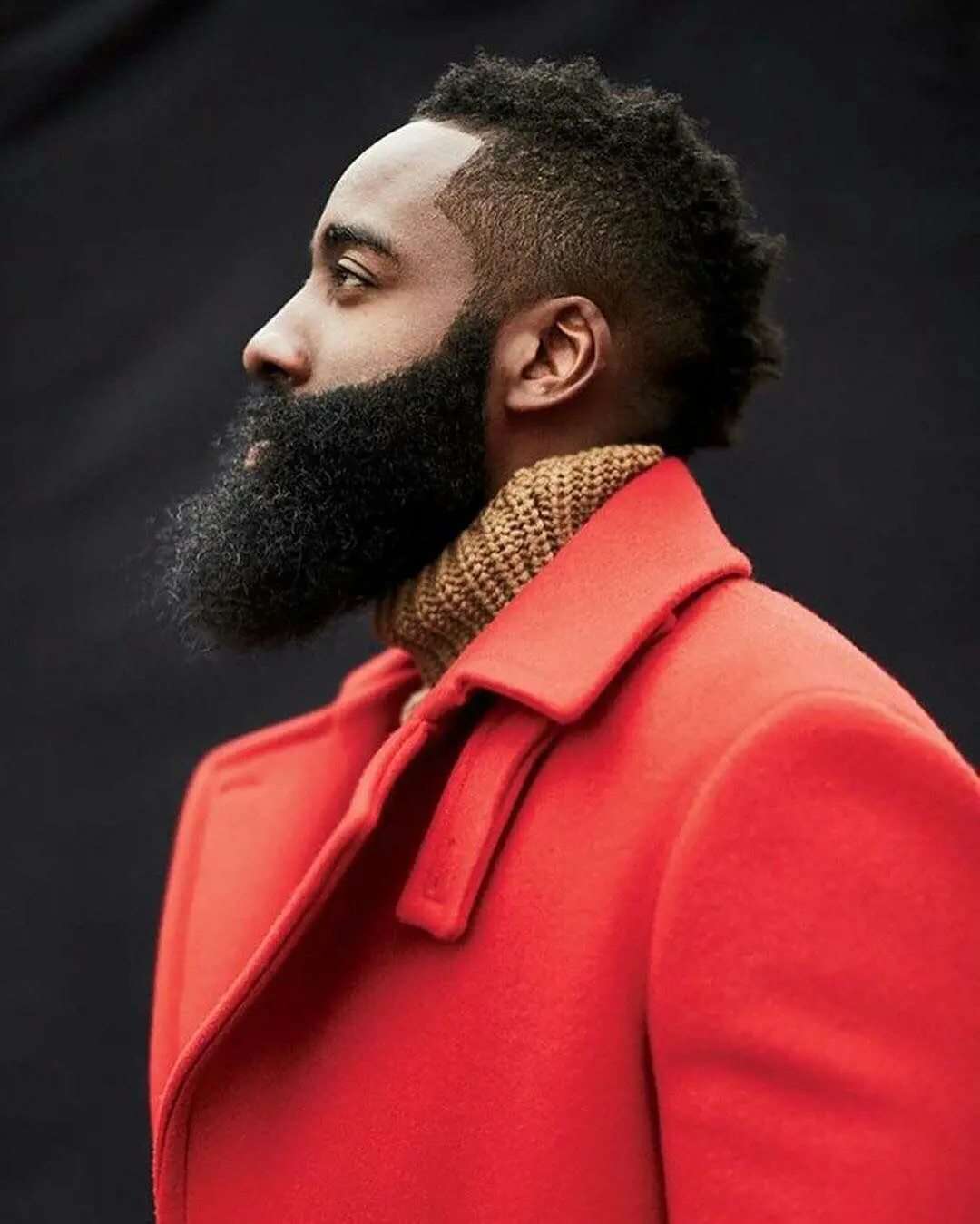 James Harden looks chic in a orange long coat and his iconic hirsute chin