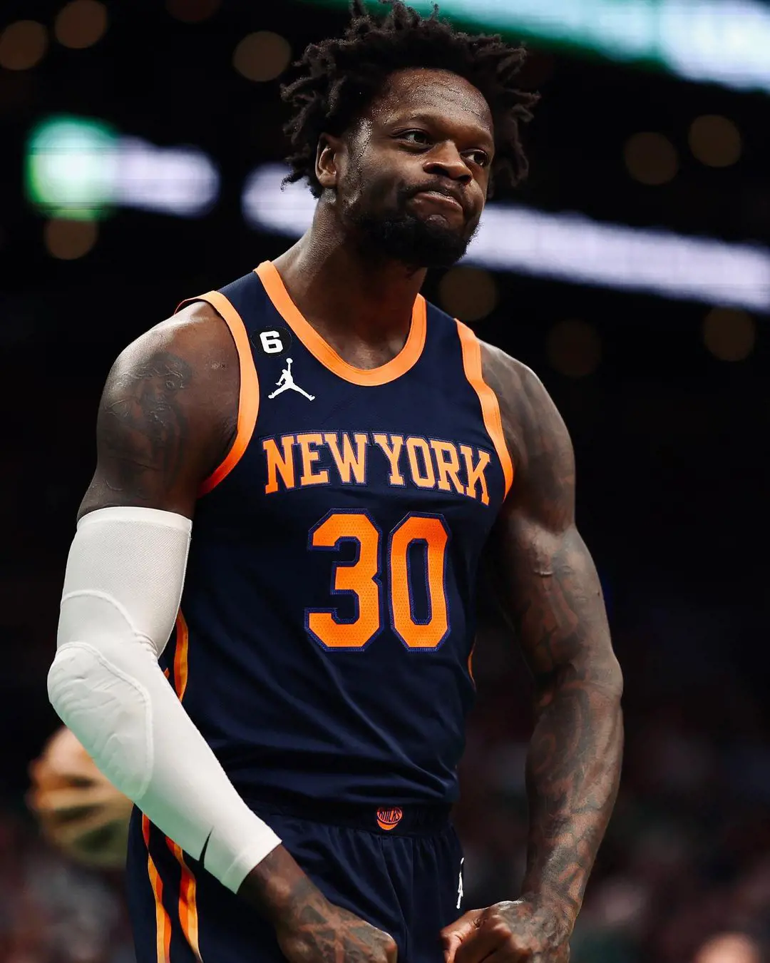 Julius Randle playing for the Knicks in 2023 season, he is seen hugging with a fan after the game